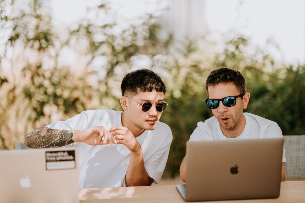Artists working on computer outside