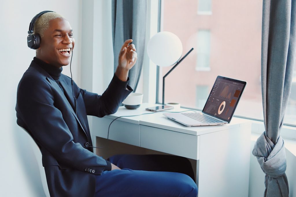 Man listening to music with headphones smiling